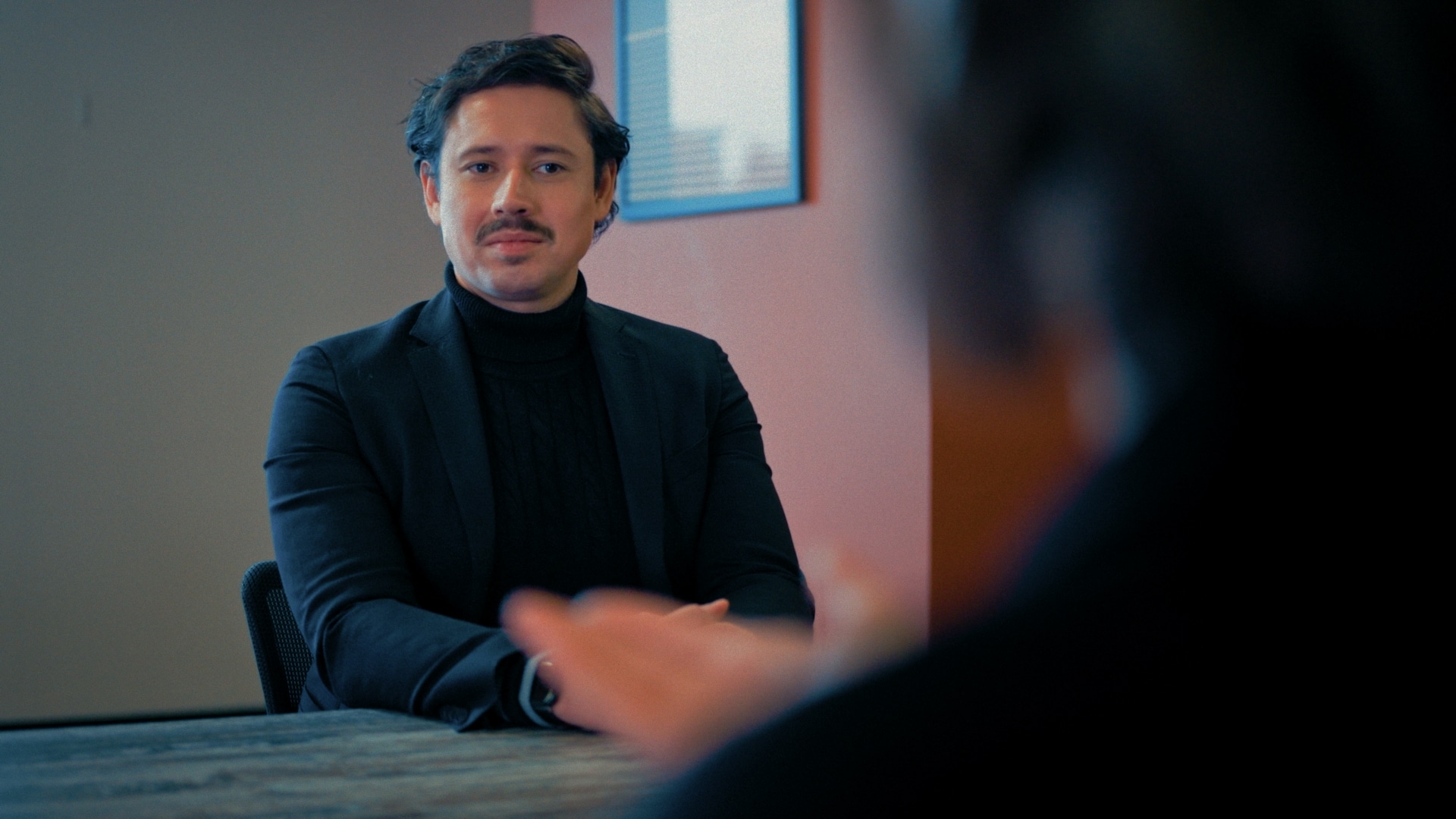John discussing work with the team
